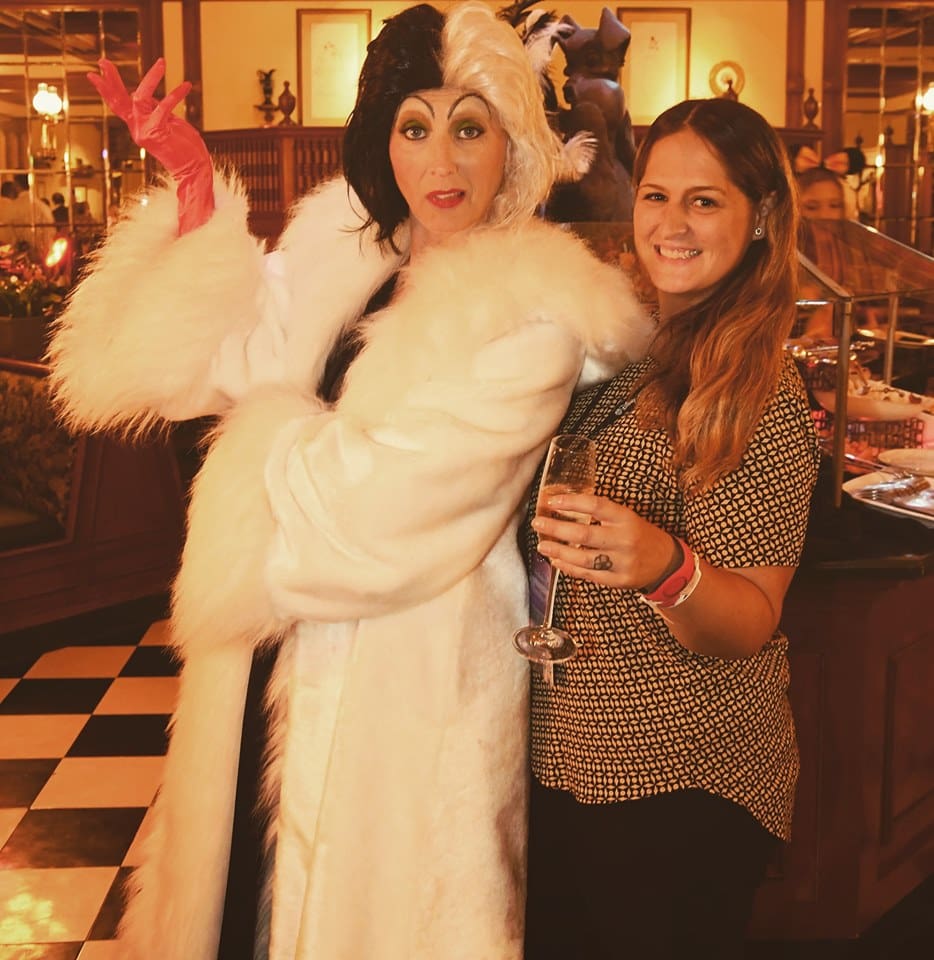 A woman posing with a person dressed as cher.