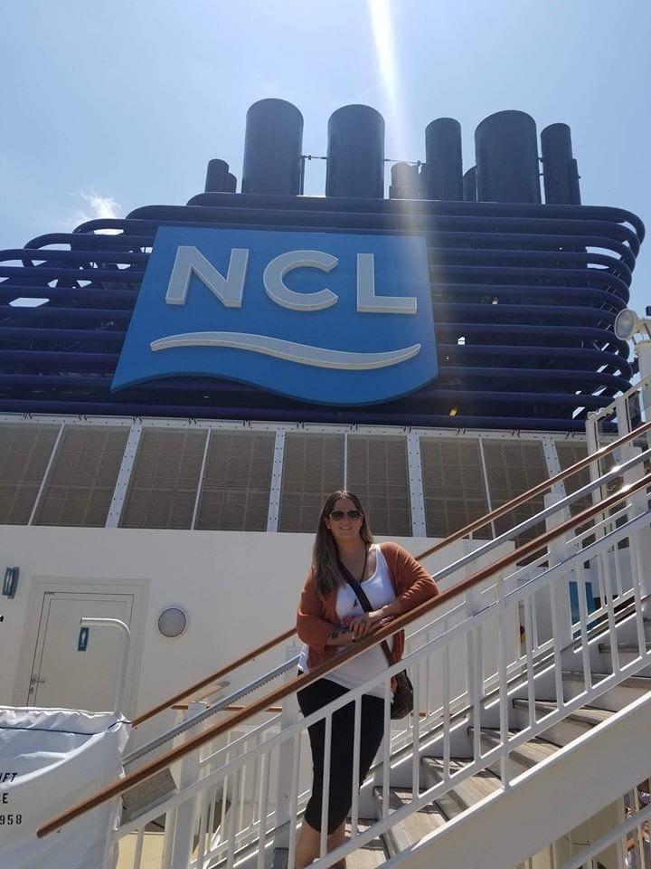 A woman standing on the stairs of a building.