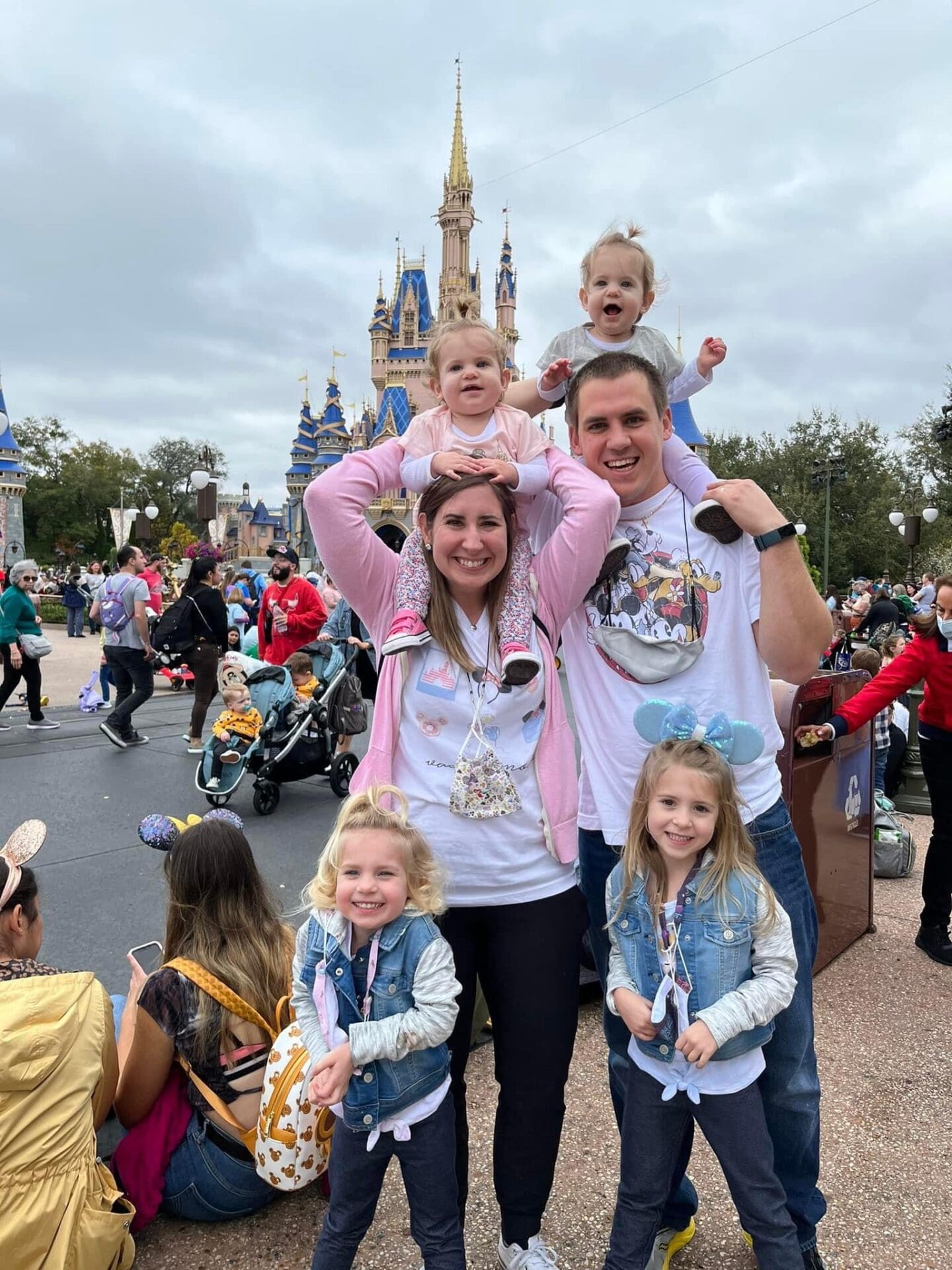 A family posing for the camera in front of a castle.