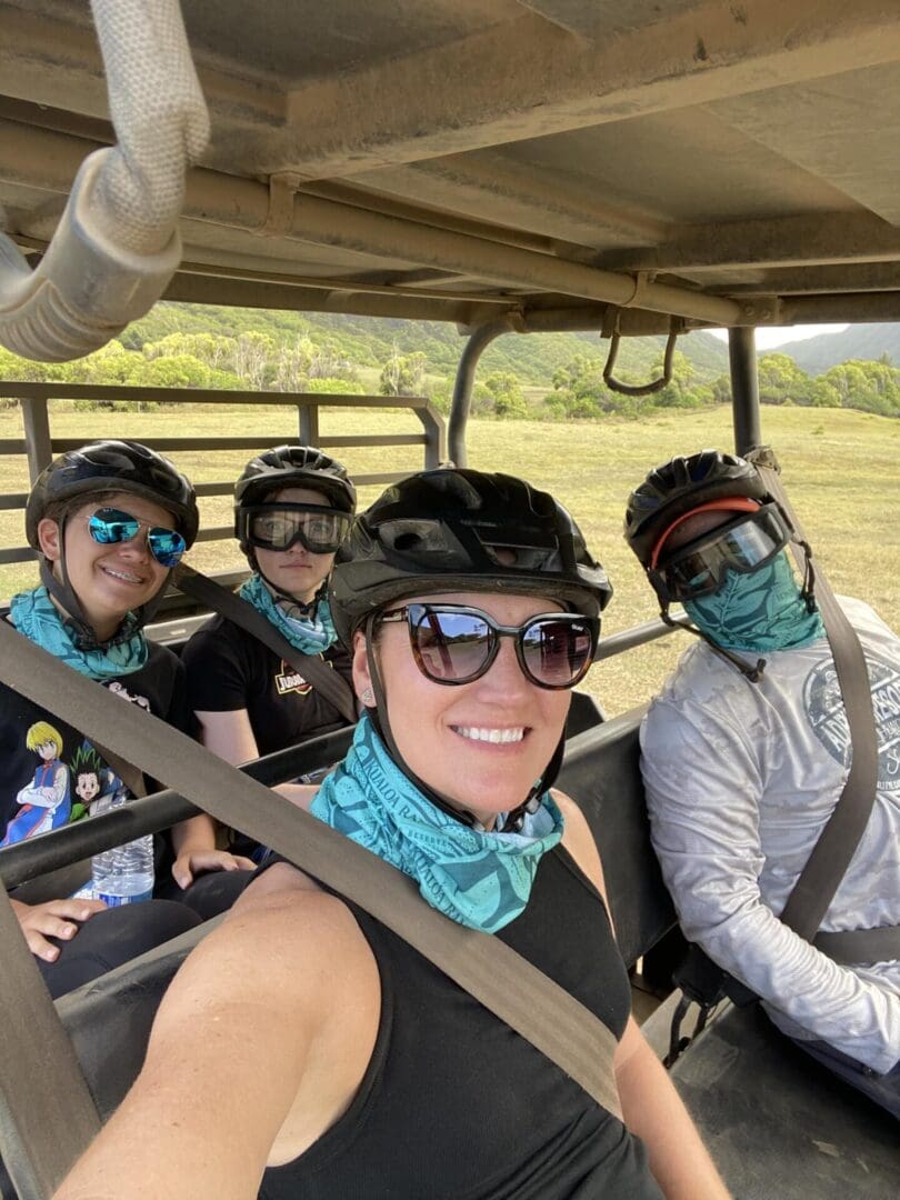 A group of people riding in the back of an atv.