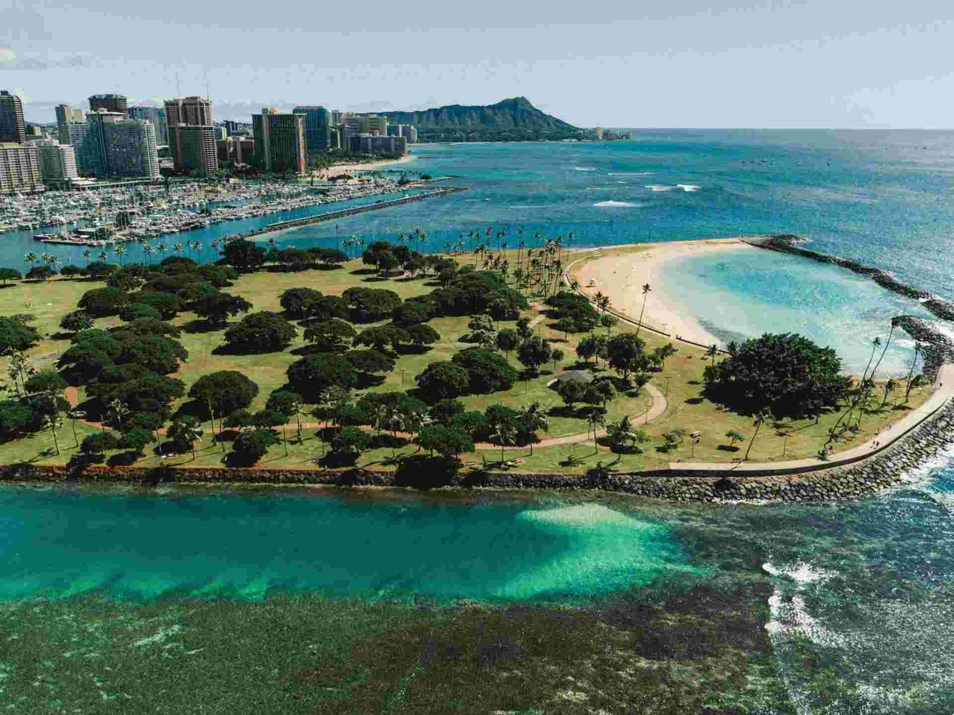 An aerial view of a beach with people swimming in it.