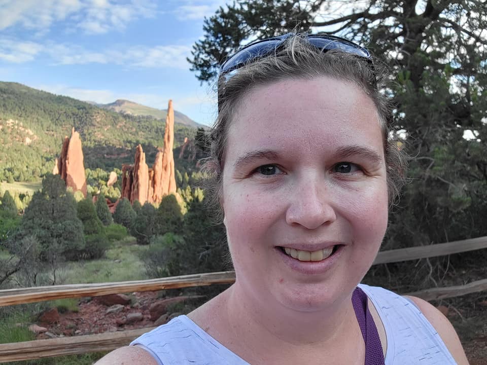 A woman standing in front of some mountains