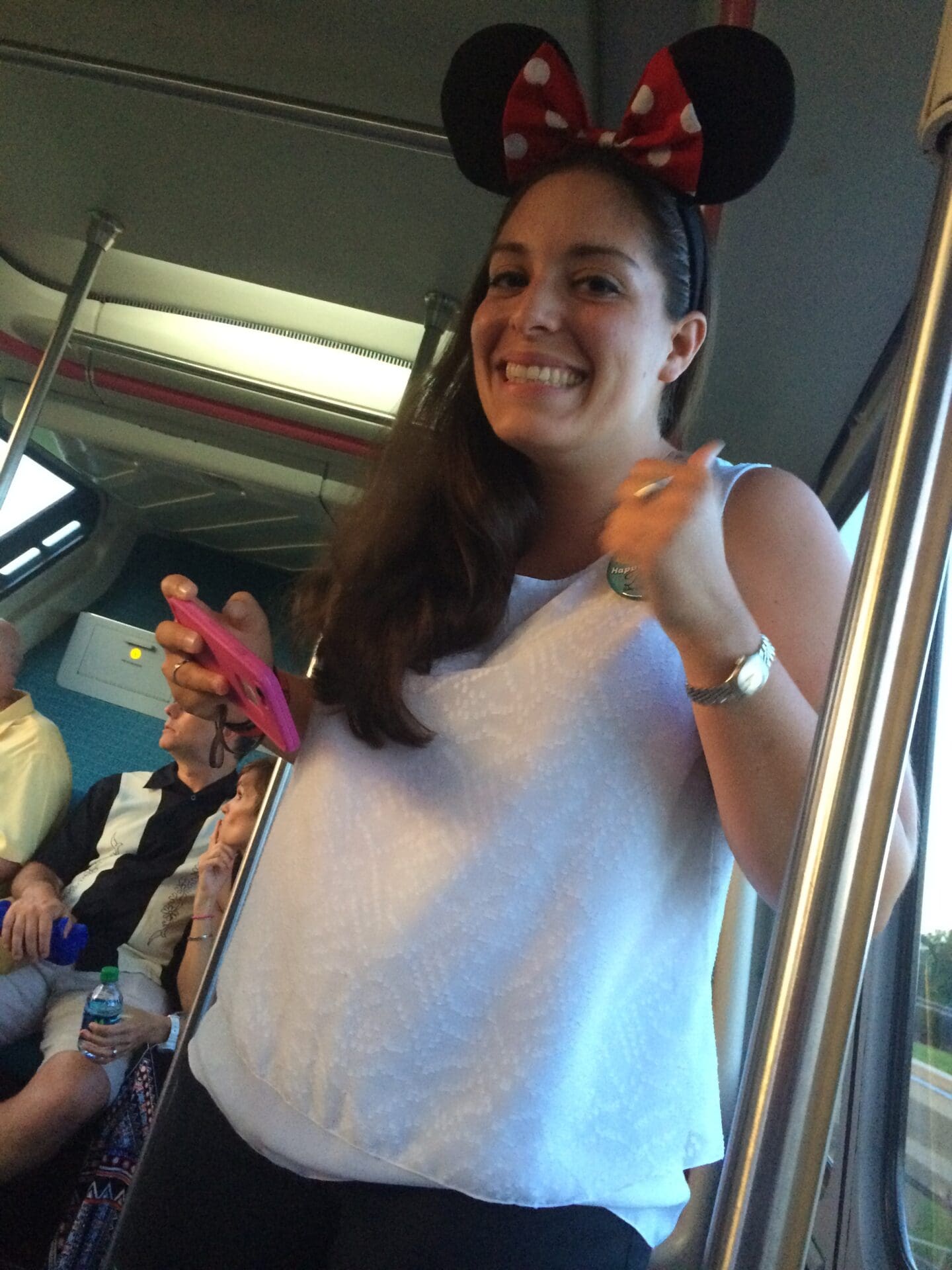 A woman with minnie mouse ears on her head.