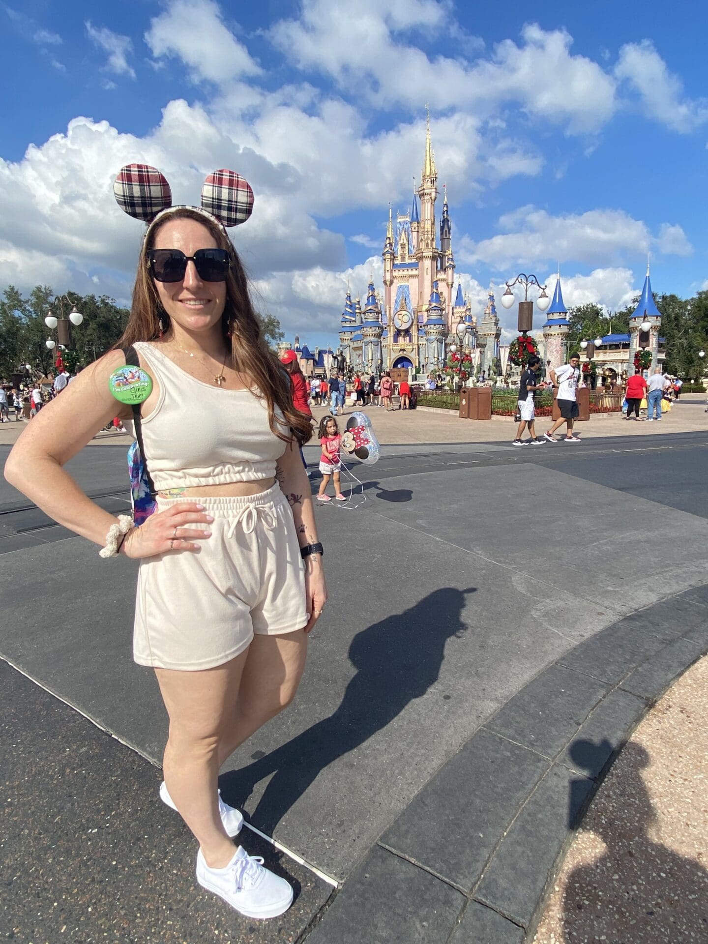 A woman standing in front of a castle.