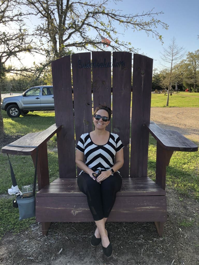 A woman sitting on top of a giant chair.