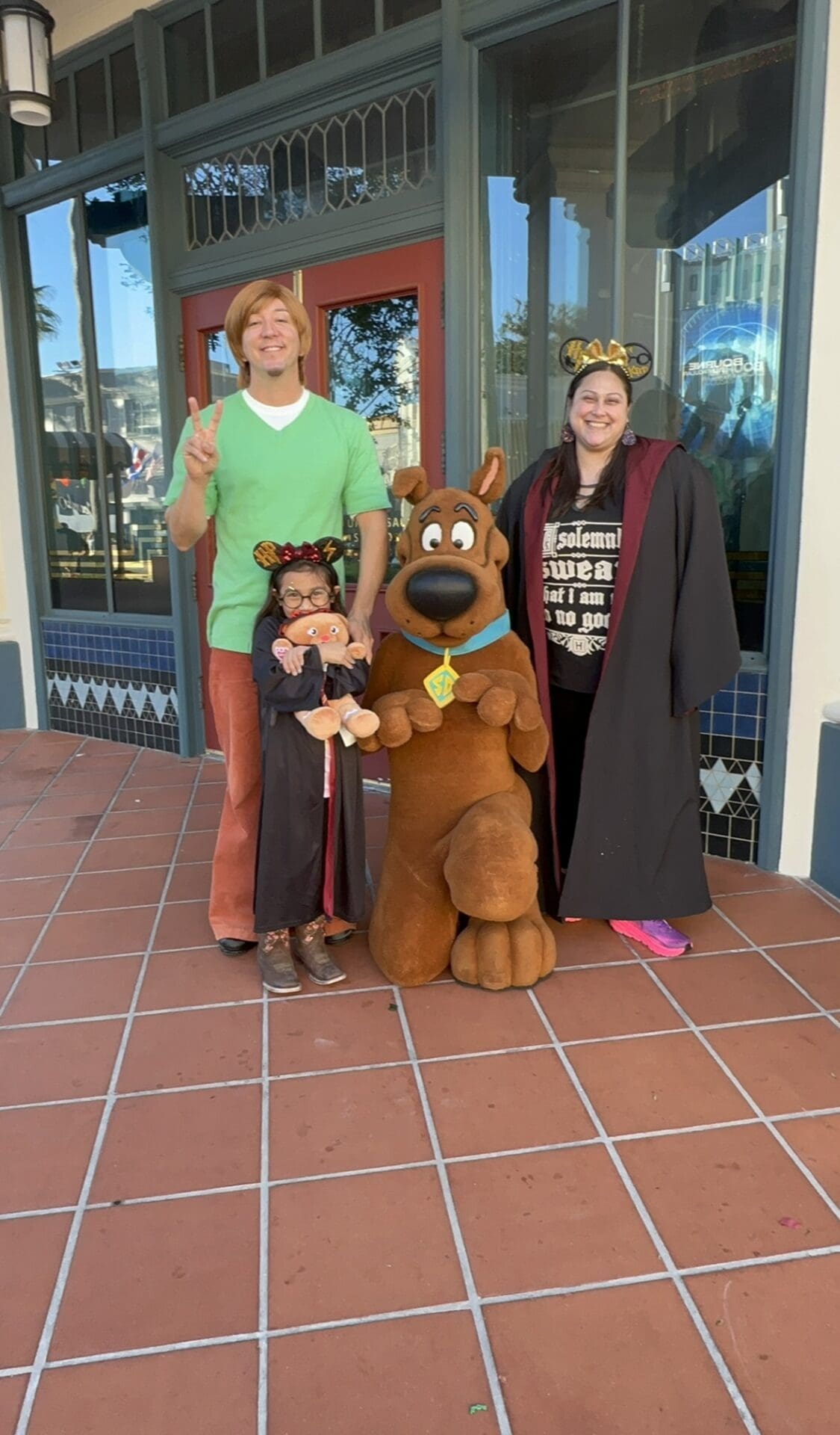 A family posing for a picture with scooby doo.