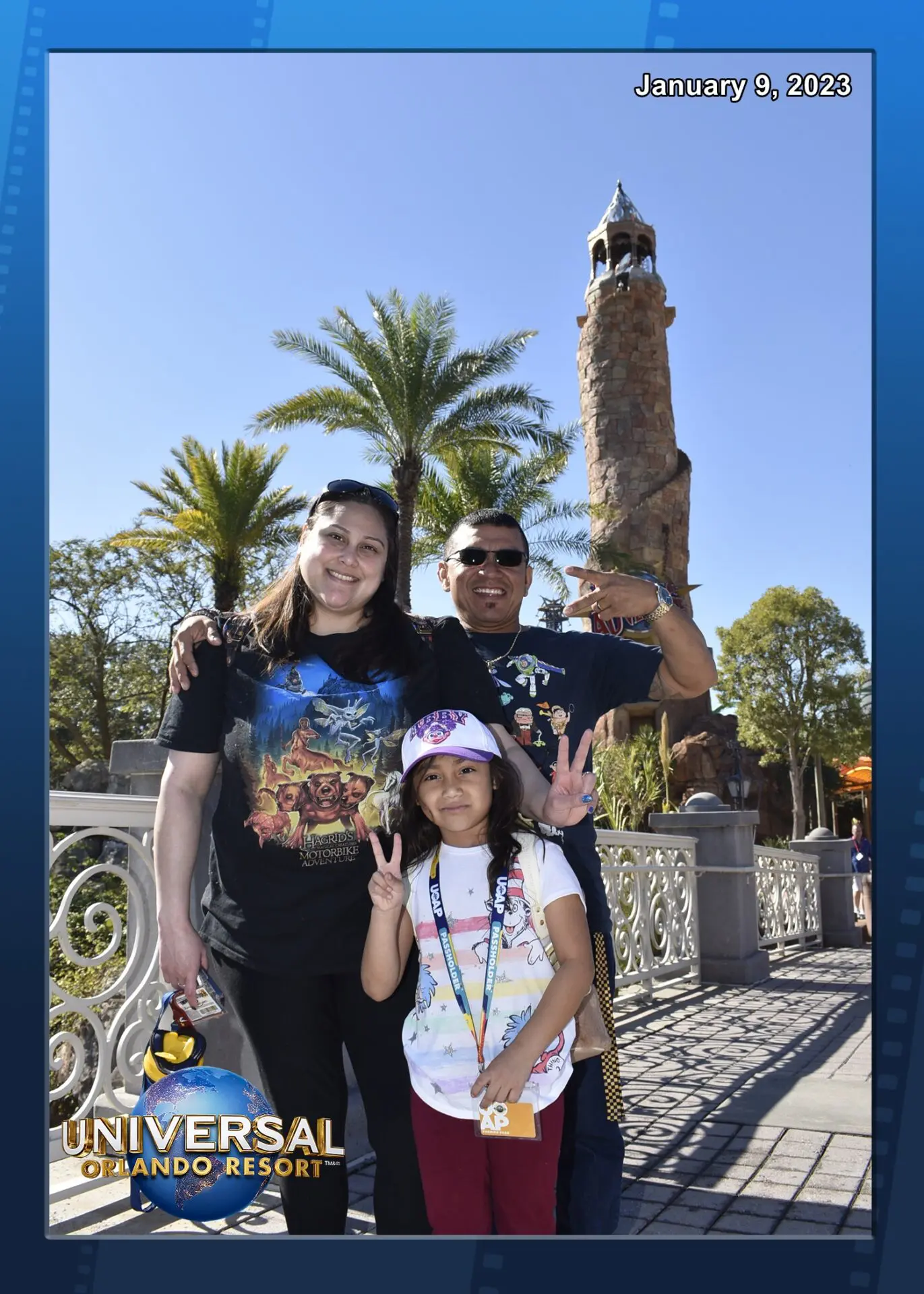 A family posing for a picture in front of a palm tree.