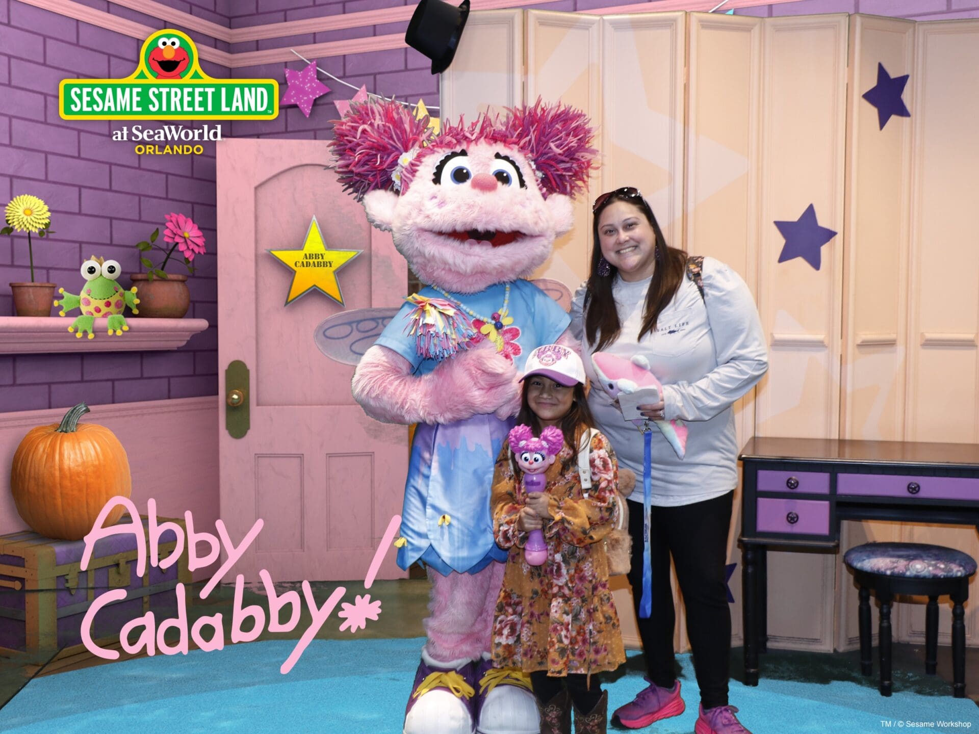 A woman and girl posing with abby cadabby.