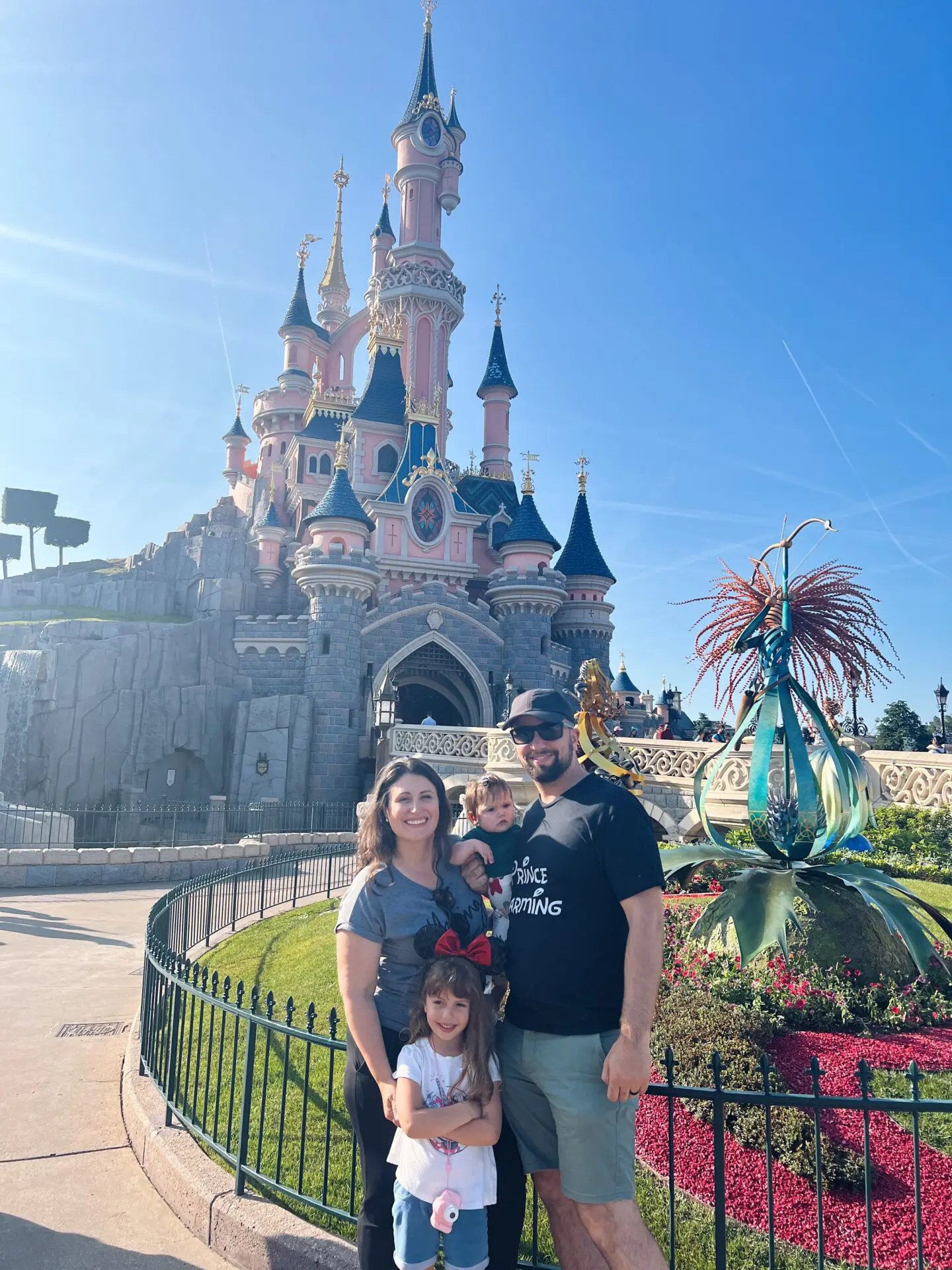 A family posing in front of the castle.