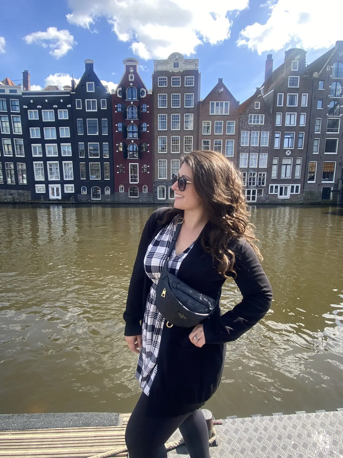 A woman standing in front of some buildings