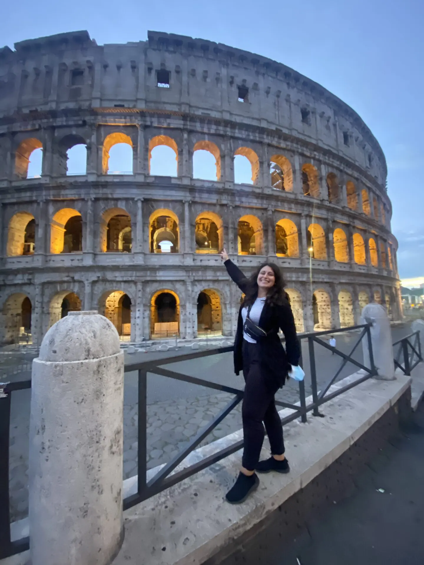 A woman standing in front of an old building