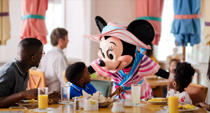A child sitting at the table with minnie mouse.
