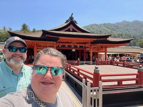 Couple in front of Japanese temple.