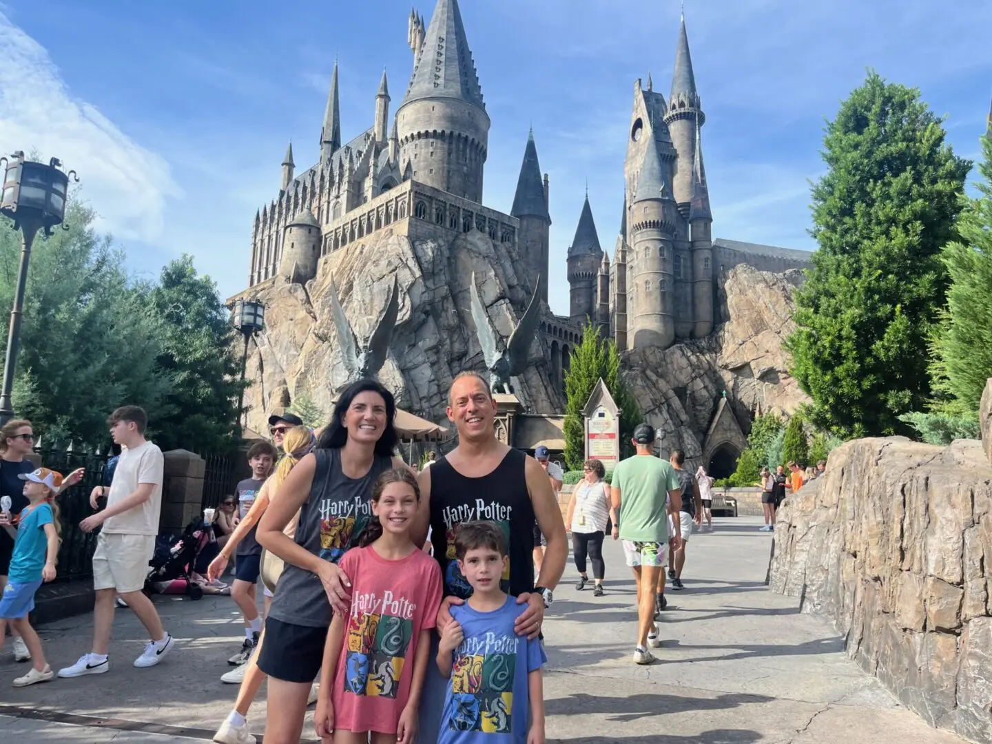 Family posing in front of Hogwarts castle.