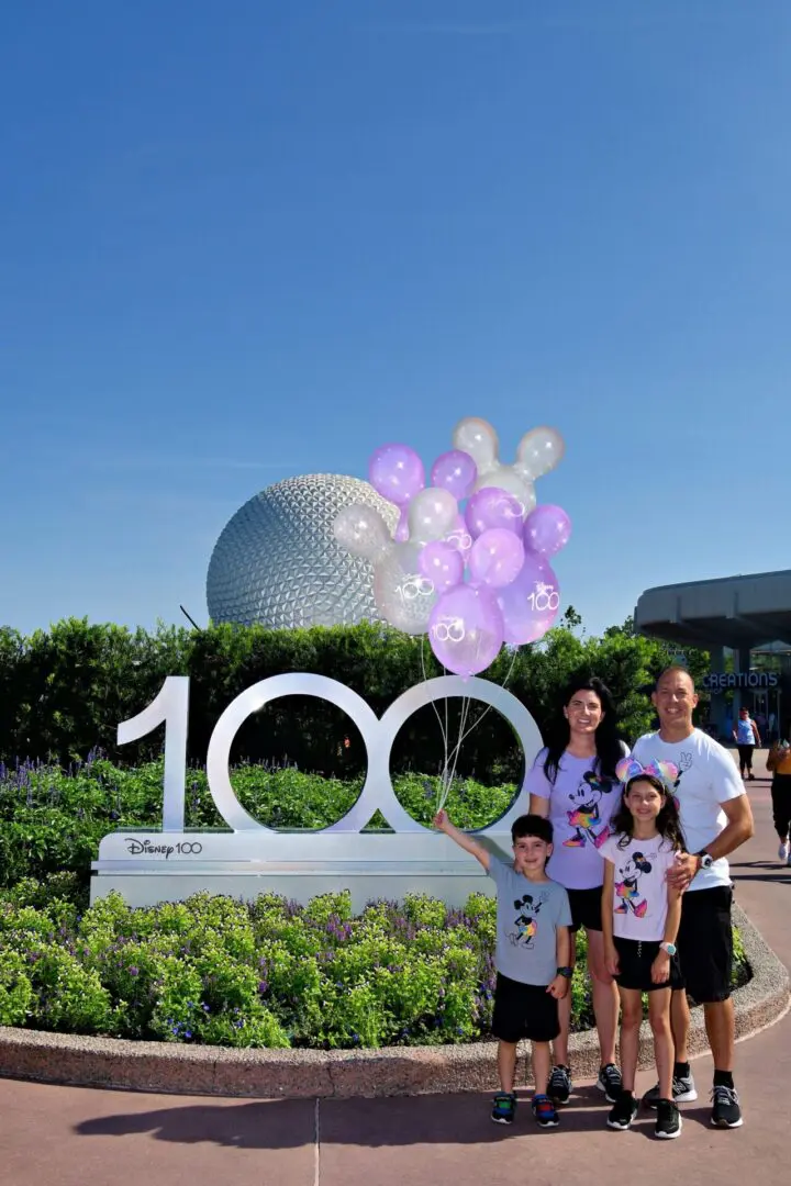 Family celebrating Disney's 100th anniversary.