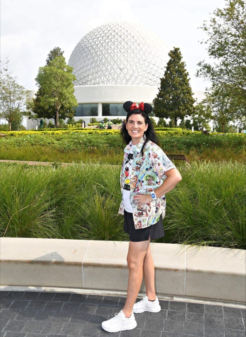 Woman with Mickey ears by Spaceship Earth.