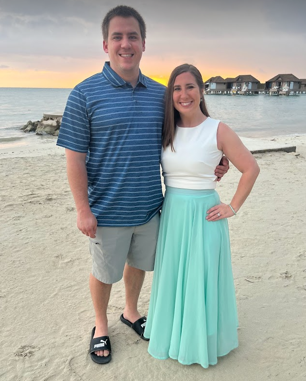 Couple on beach at sunset.