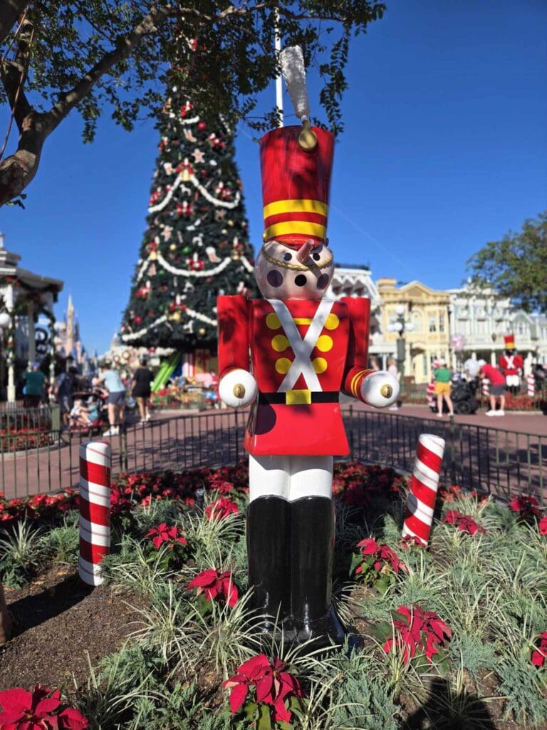 Large nutcracker by Christmas tree.